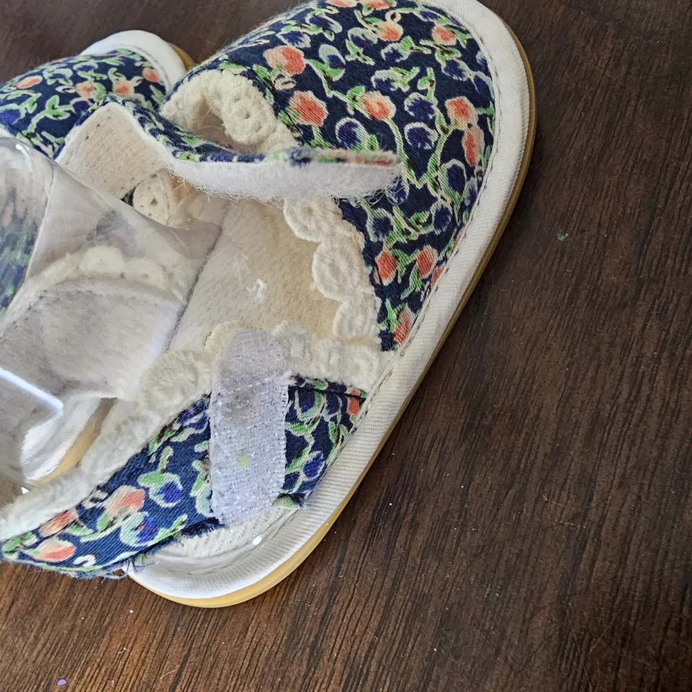 3 pairs of baby/girl shoes—soft, floral, and glittery—in various styles.